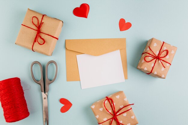 Papel con pequeñas cajas de regalo y corazones.