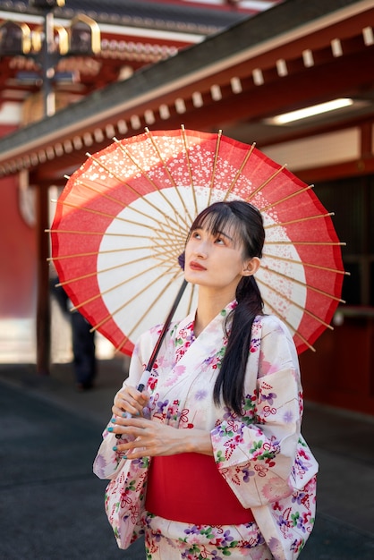 Paraguas wagasa japonés ayudado por mujer joven