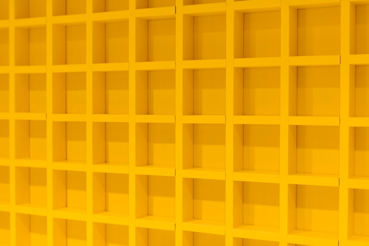 Foto gratuito pared amarilla 3d con patrón repetitivo.