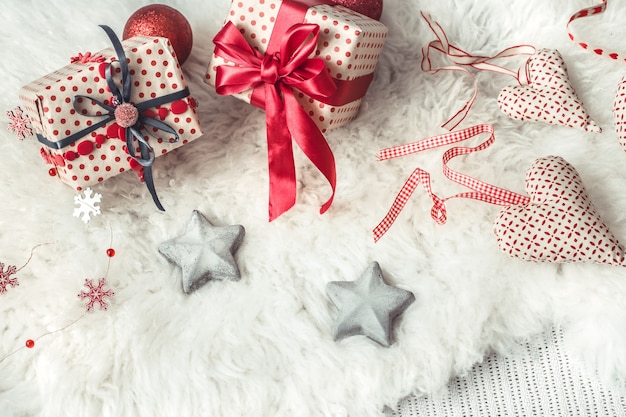 Pared festiva con un regalo de Navidad y artículos de decoración navideña.