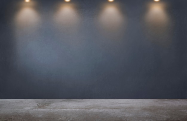 Pared gris oscuro con una fila de focos en una habitación vacía