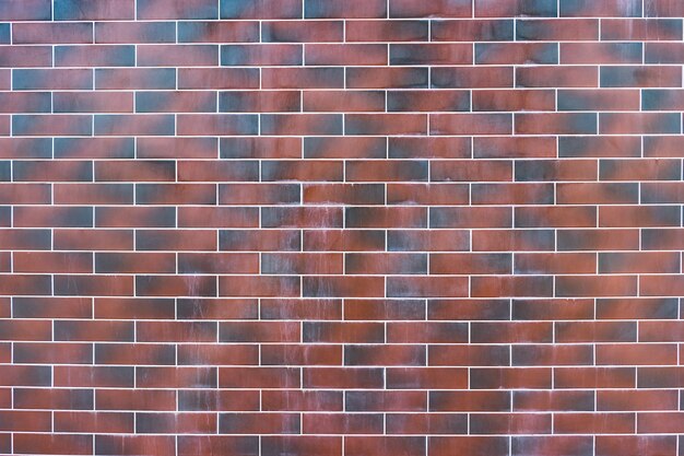 Pared de ladrillo rojo. Textura de ladrillo rojo y marrón oscuro con relleno blanco