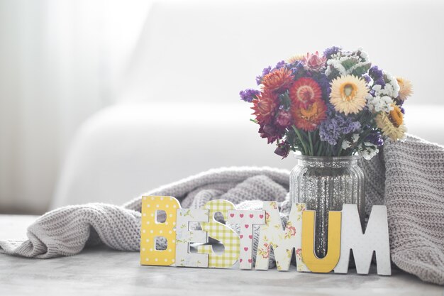 Pared de vacaciones del día de la madre, con flores y letras.