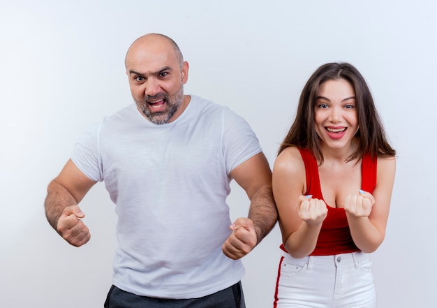 Foto gratuita pareja adulta confía en hombre y mujer alegre y aprieta los puños aislados en la pared blanca