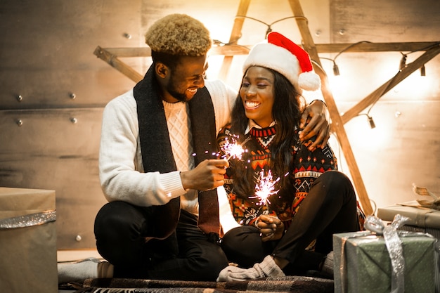 Pareja afroamericana, sentado, con, luces de bengala