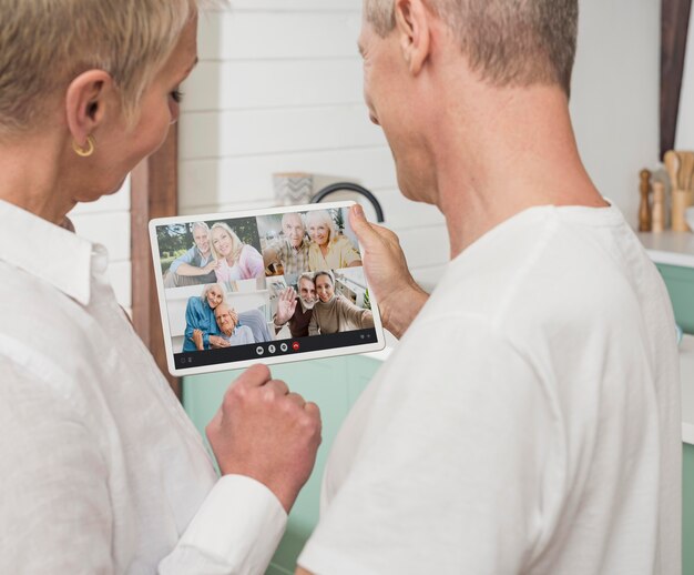 Foto gratuita pareja de ancianos llamando a sus amigos en videollamada