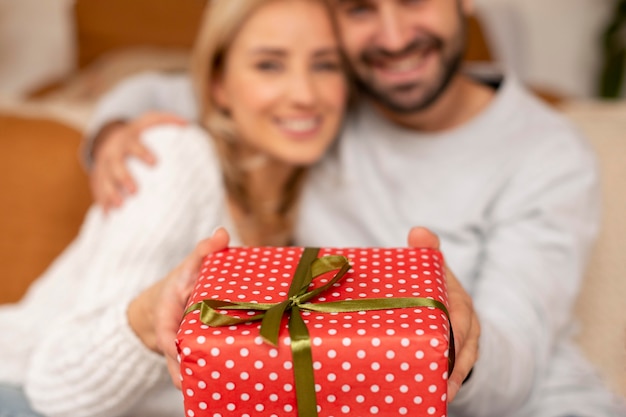 Pareja borrosa sosteniendo presente