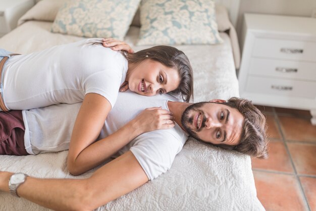 Pareja en la cama mirando a otro lado