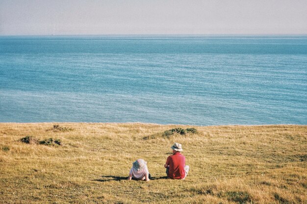 Pareja en el campo mirando el mar