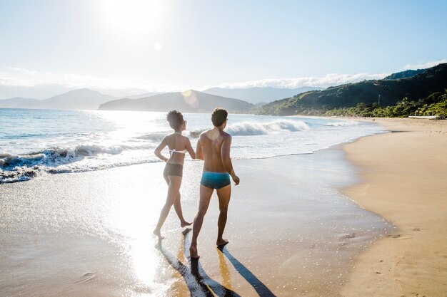 Pareja coriendo en la playa