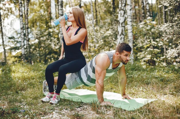 Pareja de deportes en un parque de verano por la mañana