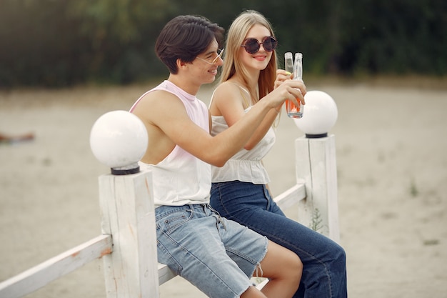 Pareja diviértete en una playa con bebidas