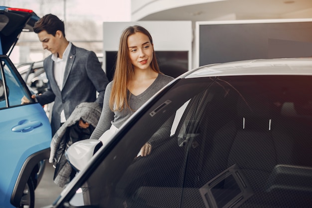 Pareja elegante en un salón de autos