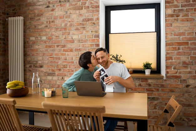 Foto gratuita pareja feliz anunciando embarazo por videollamada