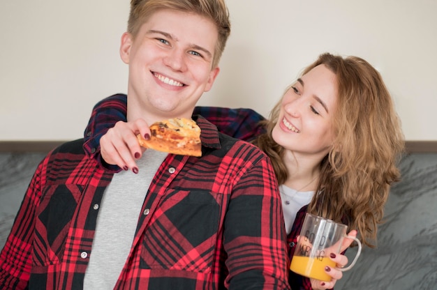 Foto gratuita pareja joven comiendo pizza