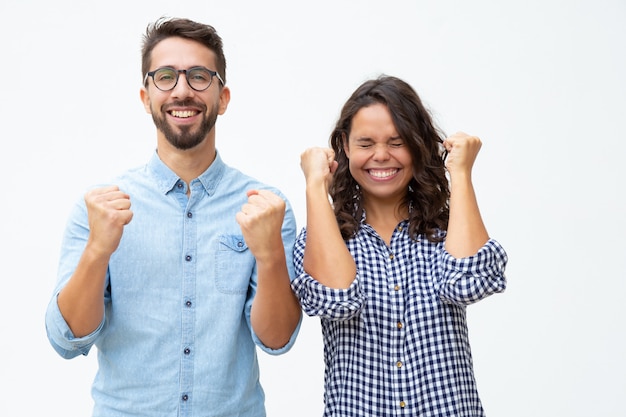 Pareja joven emocionada celebrando el éxito