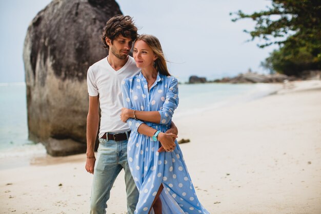 Pareja joven inconformista con estilo en el amor en la playa tropical durante las vacaciones