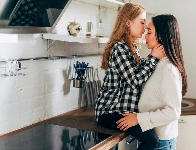 Pareja de lesbianas en casa abrazando