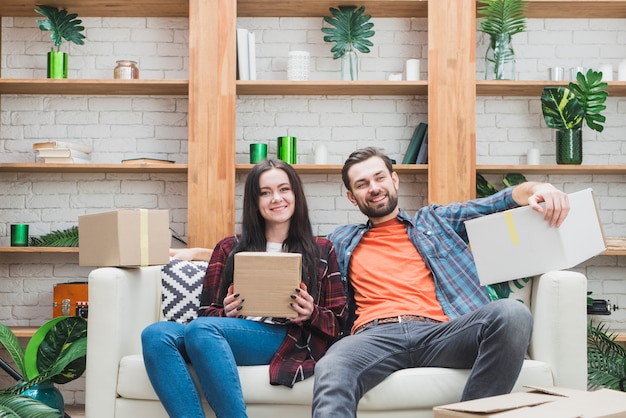 Foto gratuita pareja con paquetes en el sofá