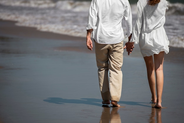 Pareja paseando por la playa durante las vacaciones