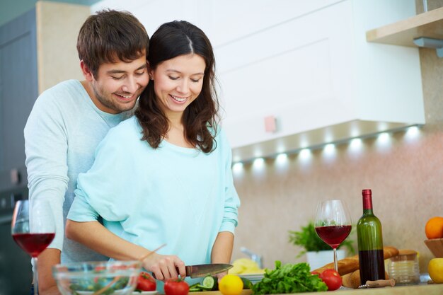 Pareja preparando una ensalada para cenar