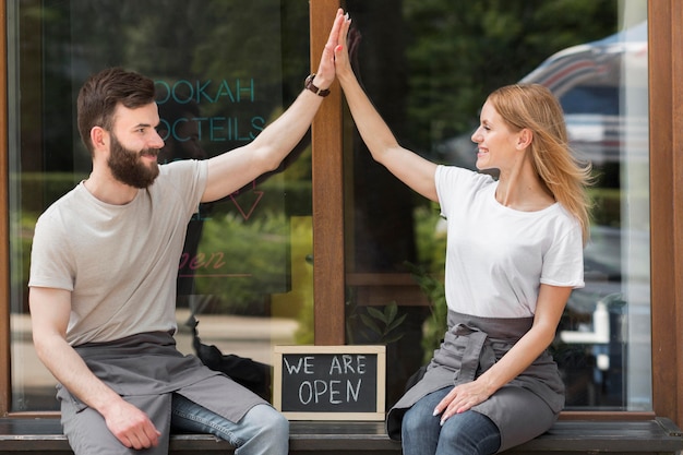 Foto gratuita pareja reabriendo pequeños negocios