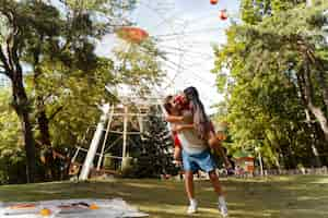 Foto gratuita pareja romántica juntos en la rueda de la fortuna en el parque