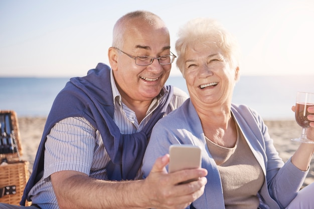 Pareja senior en la playa, la jubilación y el concepto de vacaciones de verano