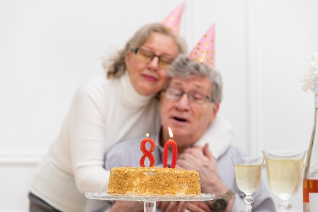 Pareja senior de tiro medio con pastel