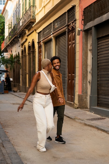 Foto gratuita pareja sonriente de tiro completo al aire libre