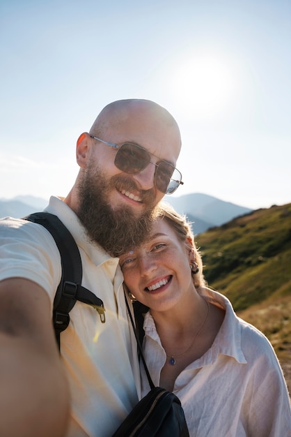 Foto gratuita pareja sonriente tomando selfie vista frontal