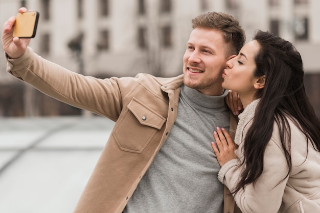 Foto gratuita pareja sonriente tomando una selfie