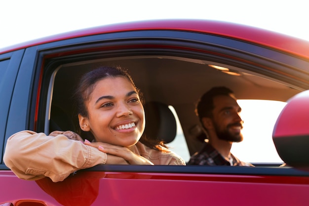 Pareja sonriente viajando en coche