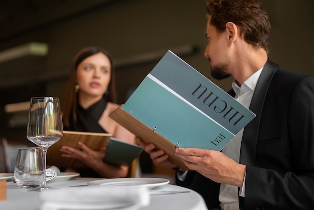 Pareja de tiro medio almorzando en un restaurante de lujo