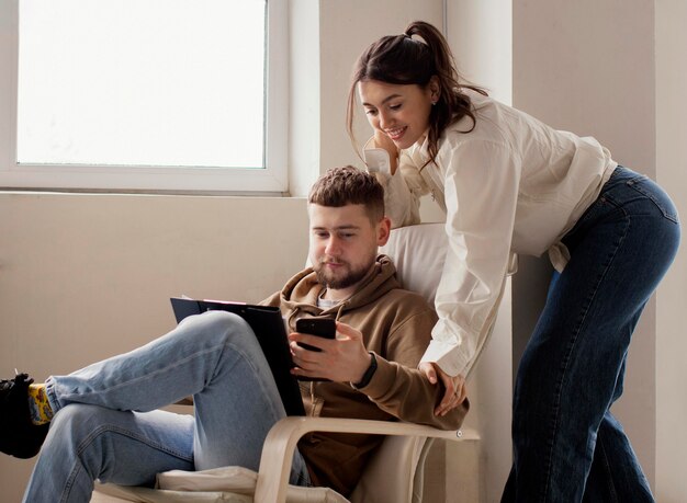 Pareja de tiro medio con smartphone