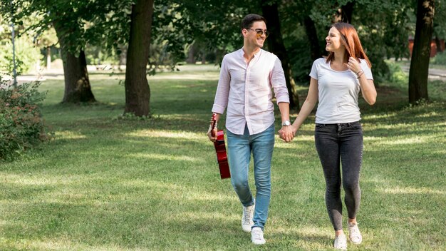 Pareja tomados de la mano en el parque