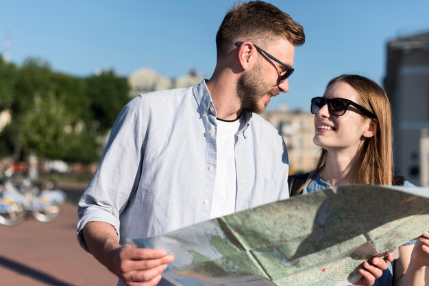 Pareja de turistas con gafas de sol y mapa