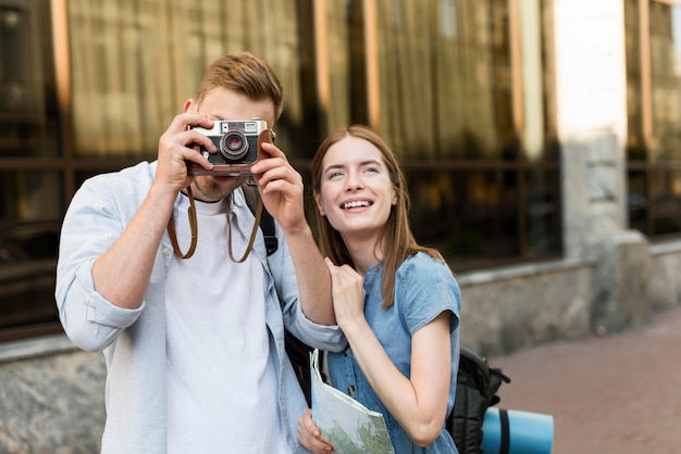 Pareja de turistas tomando fotos con cámara