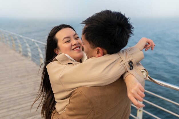 Parejas abrazándose cerca del mar