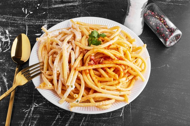 Pasta en salsa de tomate en un plato blanco.