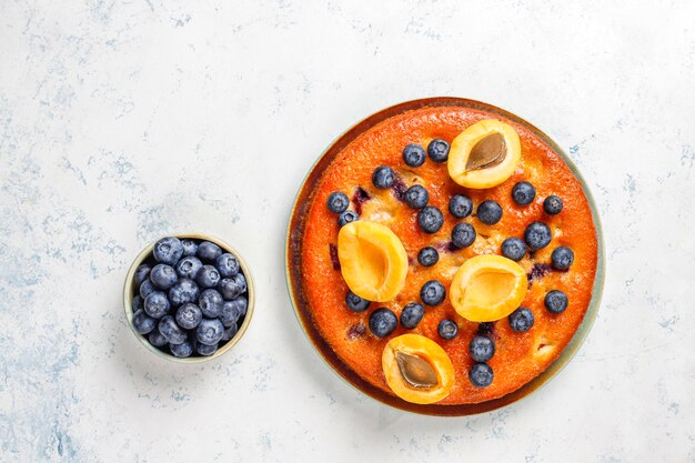 Pastel de albaricoque y arándano con arándanos frescos y frutas de albaricoque.