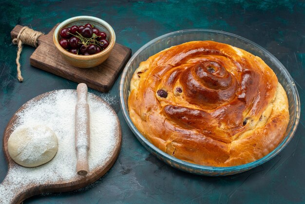 Pastel de cereza al horno con masa y guindas frescas en la oscuridad