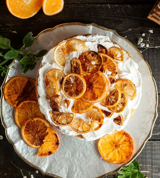 pastel con crema de limón y naranja seca en la mesa