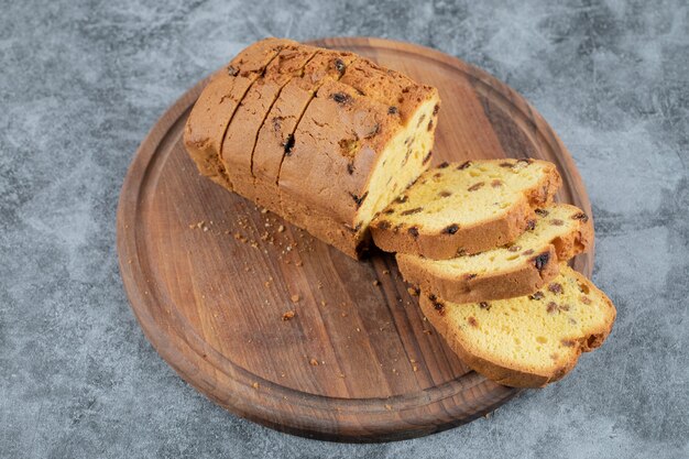 Pastel de vainilla aislado en un plato de madera rústica