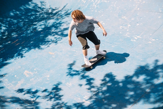 Patinador practicando y montando patineta