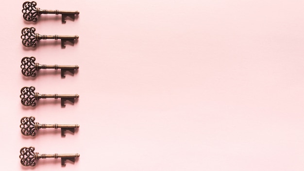 Foto gratuita patrón de llaves vintage sobre fondo rosa