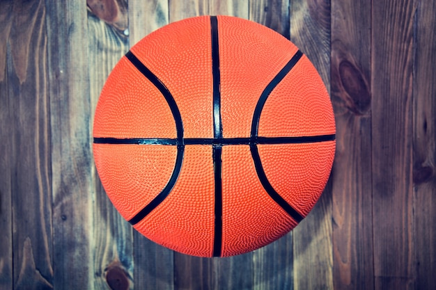 Pelota de baloncesto en piso de madera de madera dura.