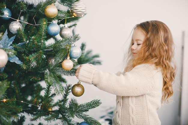 pequeña niña rubia ayudando a decorar