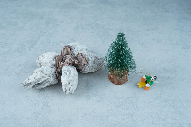 Pequeño árbol de Navidad con frutos secos saludables sobre fondo de mármol. Foto de alta calidad