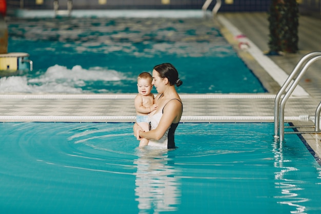 Pequeño bebé lindo. madre con hijo. familia jugando en un agua